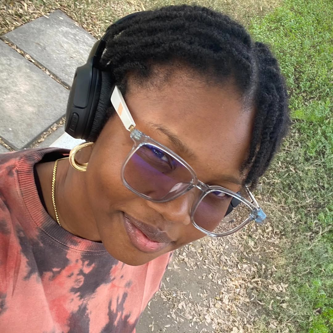 Adaku Ogbonna outdoors wearing headphones